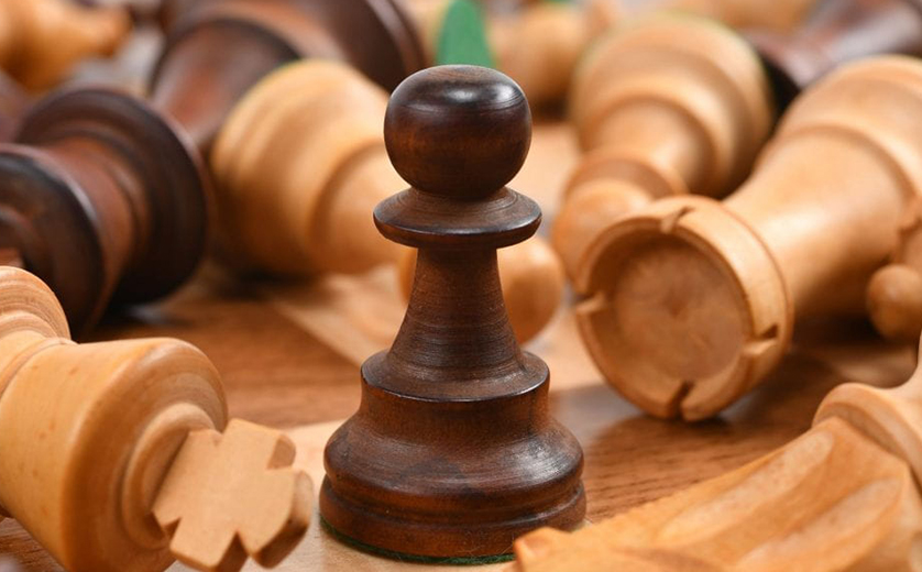 Chess pieces on board; pawn in center, other pieces knocked over