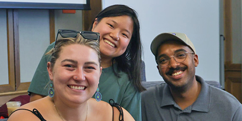 Three students in a classroom.