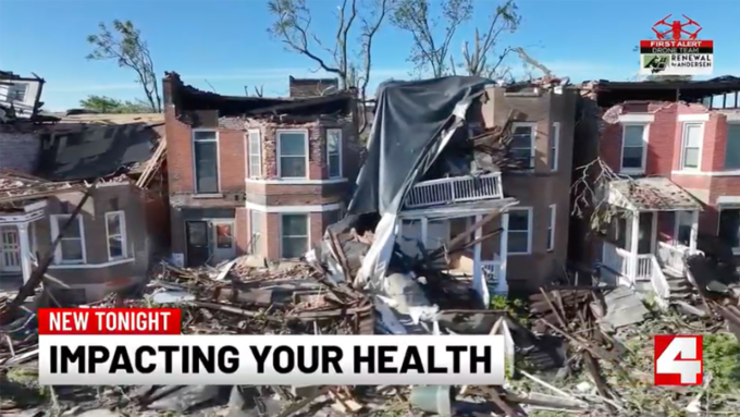 Ruined brick townhouses with collapsed roofs and rubble covering the street; bottom news banner reads 'NEW TONIGHT IMPACTING YOUR HEALTH'.