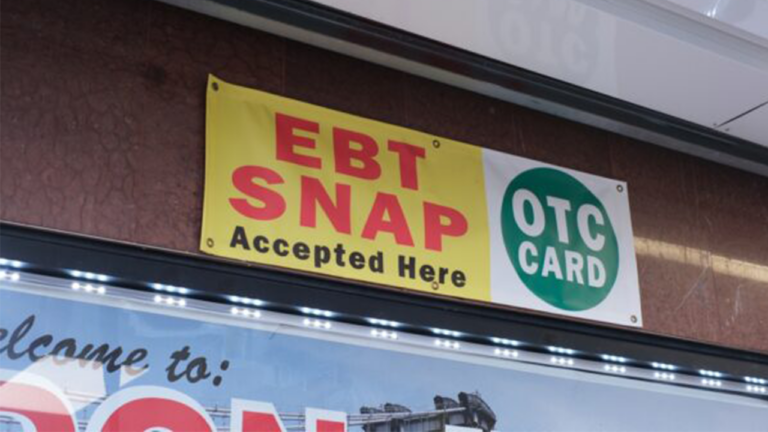 Retail storefront sign: 'EBT SNAP Accepted Here' with a green OTC CARD logo.