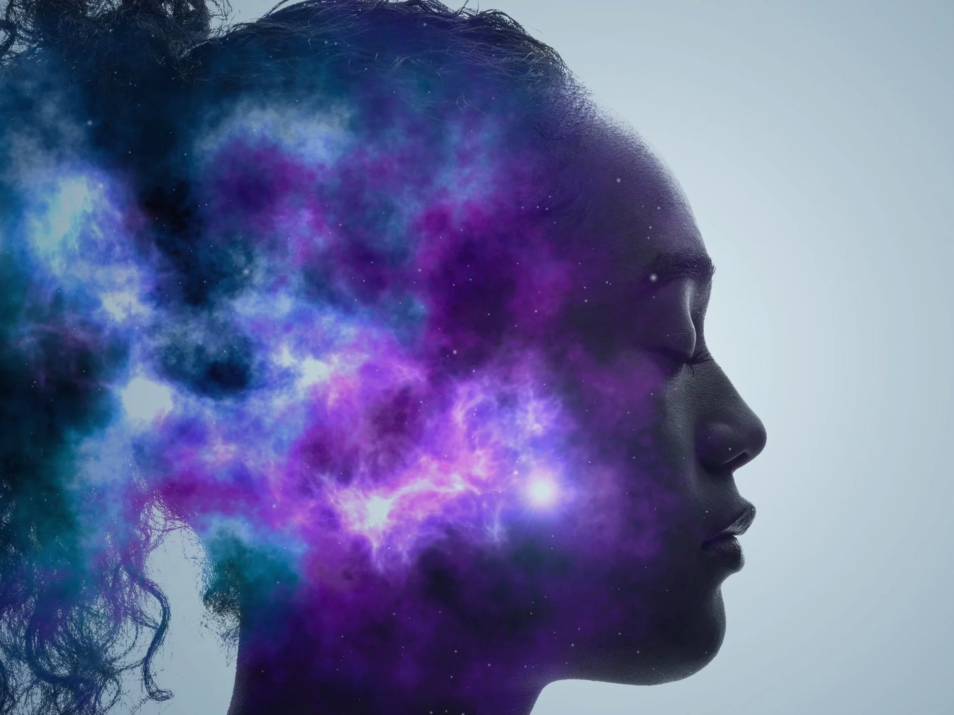 Profile of a woman's side-view head with blue-purple nebula clouds overlaying the face and neck region.