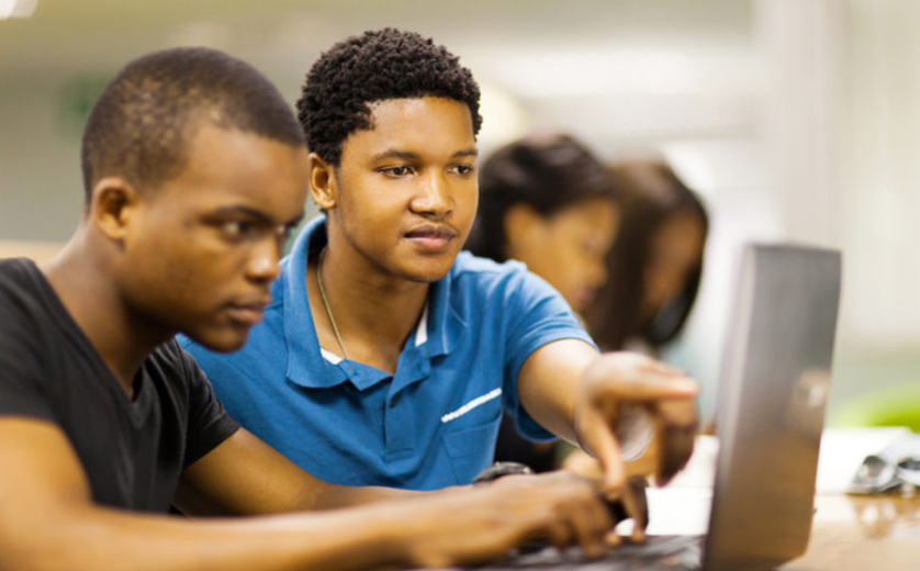 Image of Two High School students working on laptop computer