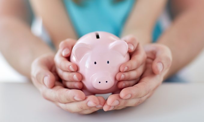 Parent and child with piggy bank