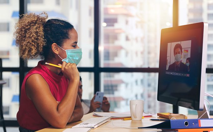 Student and professor wear masks for a remote video class