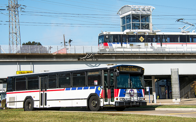 Photo of train on platform, bus leaving metro station in St. Louis, MO