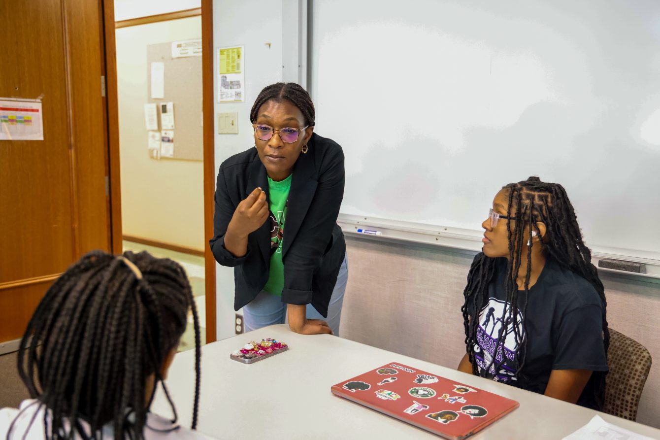 Brown School Professor Sheretta Butler-Barnes (center) discusses survey design with participants of the Girls Inc. Eureka! program.